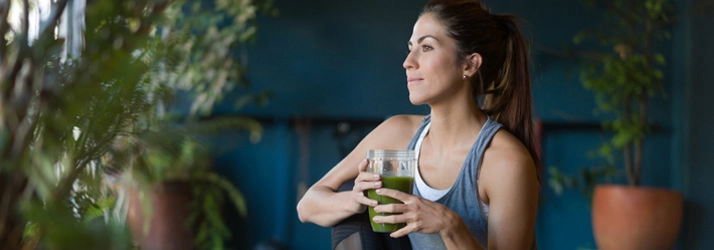 Woman drinking a smoothie.