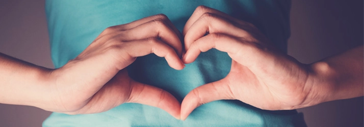 Chiropractic Cockeysville MD Heart Hands Person making heart hands.