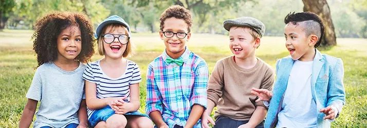 Chiropractic Cockeysville MD Laughing Kids Outside 5 kids that are sitting outside laughing.
