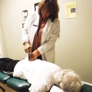 Chiropractor Cockeysville MD MaryAnn Ley Activator Method Technique Dr. MaryAnn Ley using the Activator Method Technique on a patient.